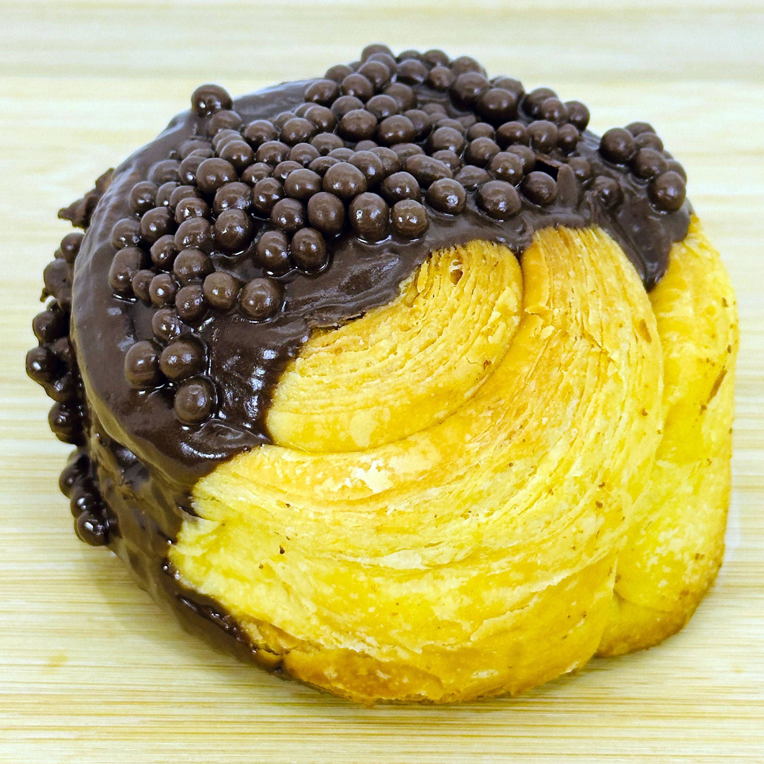Chocolate pastry roll with glossy chocolate topping